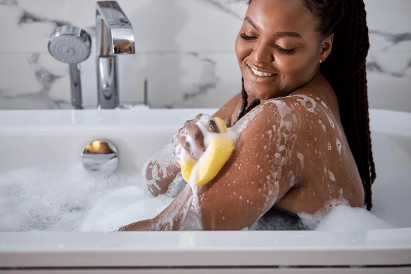 afro woman washing herself taking 600nw 1971318875